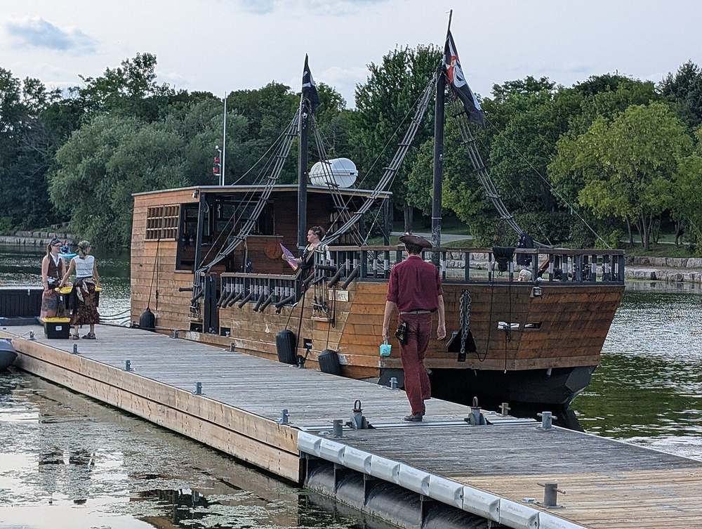 Tall pirate ship with full sails on the open sea — generate your own pirate ship name